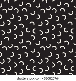 Vector seamless pattern. Inspired by Memphis Design. Randomly spaced halves of rings. Abstract geometric background.