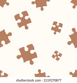 Vector seamless pattern with jigsaw puzzle pieces. Color brown and beige. 