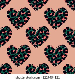 vector seamless pattern with leopard hearts in cartoon style , jaguar or cheetah coat of fur texture on hand drawn style hearts in bright colors  on beige background.