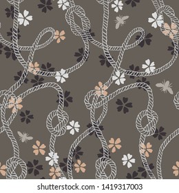 Vector seamless pattern made of twisted ropes with knots, flowers and insects. Abstract graphic drawing. Flat nautical and nature ornament. 