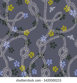 Vector seamless pattern made of twisted ropes with knots, flowers and insects. Abstract graphic drawing. Flat nautical and nature ornament. 