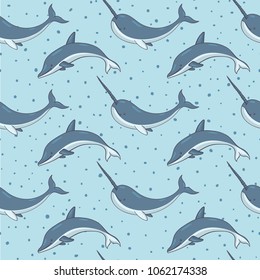 Vector seamless pattern with narwhals and dolphins on the blue polka dot background. Sea creatures and marine life backdrop.