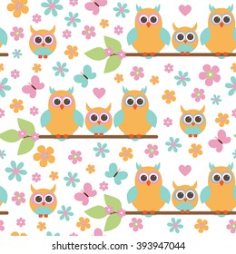 Vector seamless pattern on the theme of family. A family of owls with the children sitting on the branches, among the flowers.