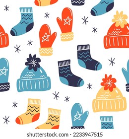 Vector seamless pattern on white isolated background. Mittens and warm socks and hats for winter holidays. Cozy winter texture for gifts, wrapping paper and others.