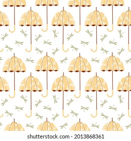 Vector seamless pattern with open umbrellas and dragonflies.