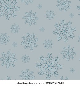 Vector seamless pattern. Openwork snowflakes on blue background.
