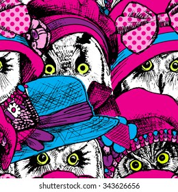 Vector seamless pattern with owls in a a pink and blue hats and bows.