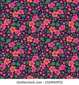 Vector seamless pattern. Pretty pattern in small flower. Small pink flowers. Dark blue background. Ditsy floral background. The elegant the template for fashion prints.