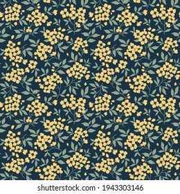 Vector seamless pattern. Pretty pattern in small flowers. Small yellow flowers. Dark blue background. Ditsy floral background. The elegant the template for fashion prints. Stock vector.