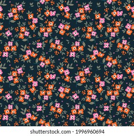 Vector seamless pattern. Pretty pattern in small flowers. Small orange and pink flowers. Dark blue background. Ditsy floral background. The elegant the template for fashion prints. Stock vector.