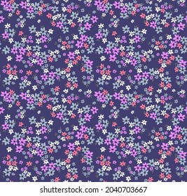 Vector seamless pattern. Pretty pattern in small flowers. Small white, pink and lilac flowers. Blue purple background. Ditsy floral background. The elegant the template for fashion prints. Stock.