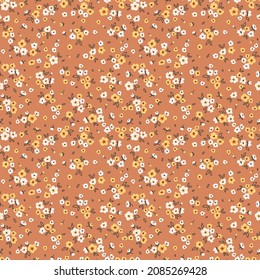 Vector seamless pattern. Pretty pattern in small flowers. Small white and yellow flowers. Earthy colors background. Ditsy floral background. The elegant the template for fashion prints. Stock.