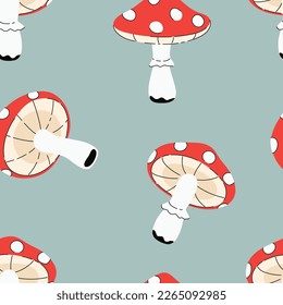 Vector seamless pattern with red fly agarics on a blue background. Amanita pattern, poisonous mushrooms freehand drawing.
