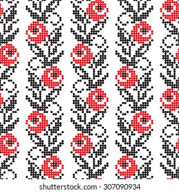 Vector seamless pattern with rose flowers. Traditional elements of Ukrainian embroidery in red and black colors. Stylized embroidery made with cross-stitches.
