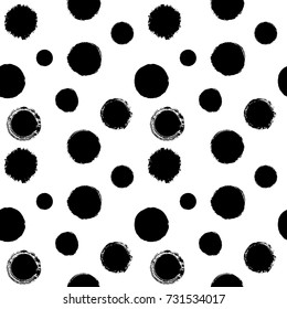 Vector seamless pattern with rough messy ink stains. Black uneven prints of round shapes on a white background.