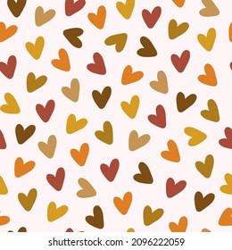 Vector seamless pattern with scattered colorful hearts on a pastel background. Modern romantic repeated texture for wallpaper, wrapping paper, fabric design