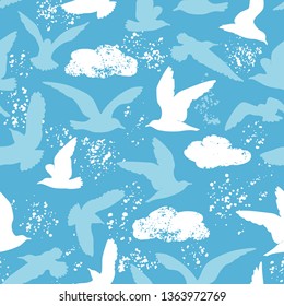Vector seamless pattern with seagulls silhoettes. Blue summer repeated texture with birds and clouds.
