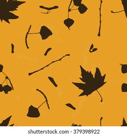 Vector seamless pattern with silhouettes of real  leaves, yellow background