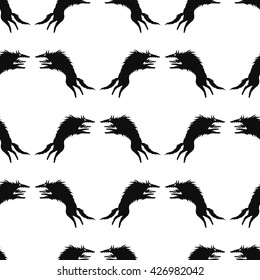 Vector seamless pattern with silhouettes of  wolf attacks. black and white