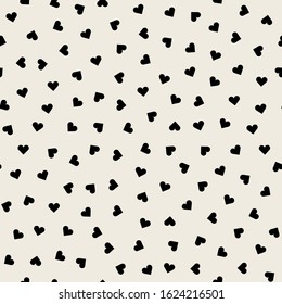 Vector seamless pattern. Simple repeating texture with scattered hearts. Stylish hipster texture. Simple minimal design for Valentine's Day.