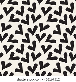 Vector seamless pattern. Simple repeating texture with chaotic hearts. Stylish hipster texture.