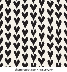 Vector seamless pattern. Simple repeating texture with chaotic hearts. Stylish hipster texture.