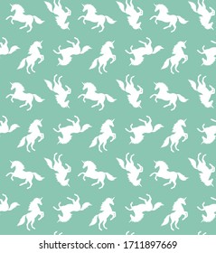 Vector seamless pattern of sketch white unicorn silhouette isolated on mint background