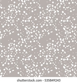 Vector seamless pattern. Soft dotted texture. Pastel background with random dots. Christmas simple print. Winter swatch with stylized snawfall.