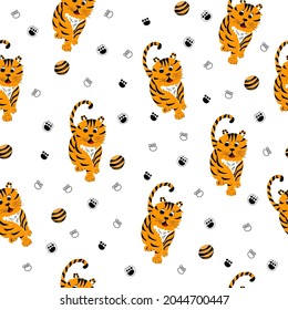 Vector seamless pattern with tiger's, paws and baby ball. Bright baby seamless pattern mockup. Bright baby seamless pattern mockup. Symbol of 2022.