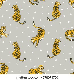 Vector seamless pattern with tigers and triangles isolated on the grey background. Animal  background for fabric or wallpaper boho design.