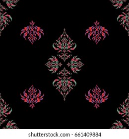 Vector seamless pattern of traditional ornamental background with violet, red and pink circular mandala, stars and snowflakes elsments on a black backdrop.