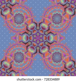 Vector seamless pattern of traditional ornamental background with purple, pink and orange circular mandala, stars and snowflakes elsments.