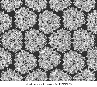 Vector seamless pattern of triangle mandalas - ethnic floral circle ornament with paisley and lotuses