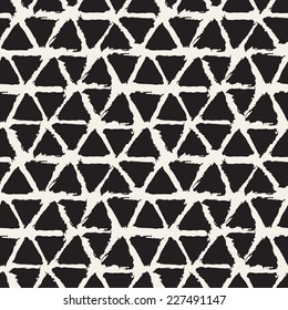 Vector seamless pattern with triangles. Abstract background. Monochrome texture from brush strokes