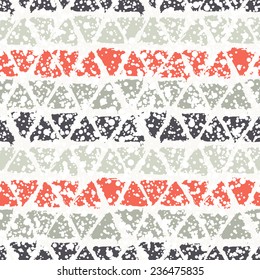 Vector seamless pattern with triangles. Christmas background with paint brush strokes. Graphical colorful texture with snowy covering. 