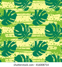 Vector seamless pattern with tropical palm leaves and strip, ink blots