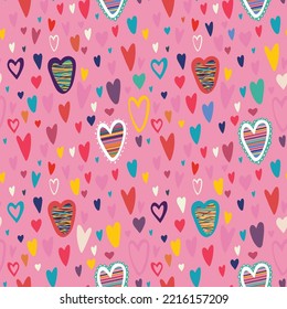 Vector seamless pattern. Valentine design. Multicolored doodle hearts on a pink backgroung.
