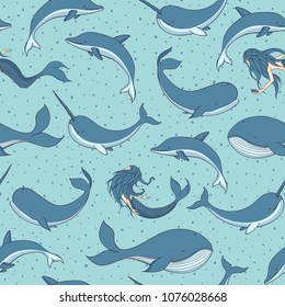 Vector seamless pattern with whales, mermaids, narwhals and dolphins on the dotted blue background. Sea creatures, sirens and marine life.