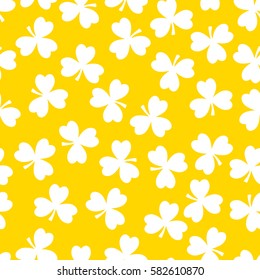 Vector seamless pattern. White clover on a yellow background. National holiday St.Patrick 's Day.