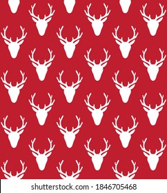 Vector seamless pattern of white deer head silhouette isolated on red background