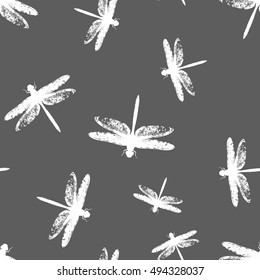 Vector seamless pattern. White dragonfly on a dark gray background.