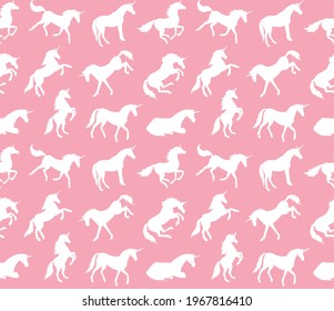 Vector seamless pattern of white hand drawn unicorn silhouette isolated on pink background