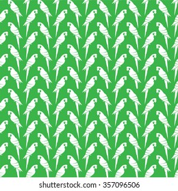 Vector seamless pattern with white parrot on green background. wallpaper