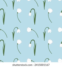 Vector seamless pattern with white snowdrop flowers and green leaves on a blue background. Botanical illustration. Field of snowdrops. 