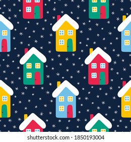 Vector seamless pattern wih houses and snowflakes. Cute winter illustration in flat style. Red, green, yellow, blue and white colors. Winter design background. White snowflakes and bright houses on bl