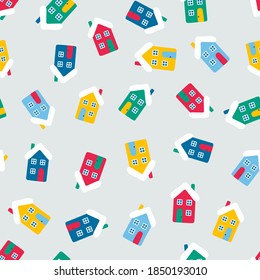 Vector seamless pattern wih houses. Cute winter illustration in flat style. Red, green, yellow, blue and white colors. Winter design background. Color house on light gray background.