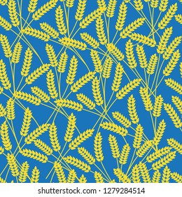 Vector seamless pattern with yellow spikelets on light blue background.