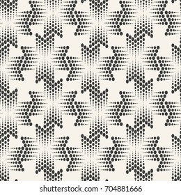 Vector seamless pattern.Halftone dots on white background.Monochrome geometric texture with repeated dots of different sizes.