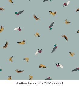 A vector seamless repeat pattern of ditsy vintage duck decoys, including mallard and red head ducks, scattered on a blue gray background.