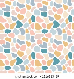 Vector seamless spotted pattern. Multicolour spots of various shapes on a white background. Many shapeless rounded shapes. Trend pattern. Leopard print. Doodle style. Stock illustration. For fabric